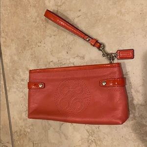 Coral colored coach handbag